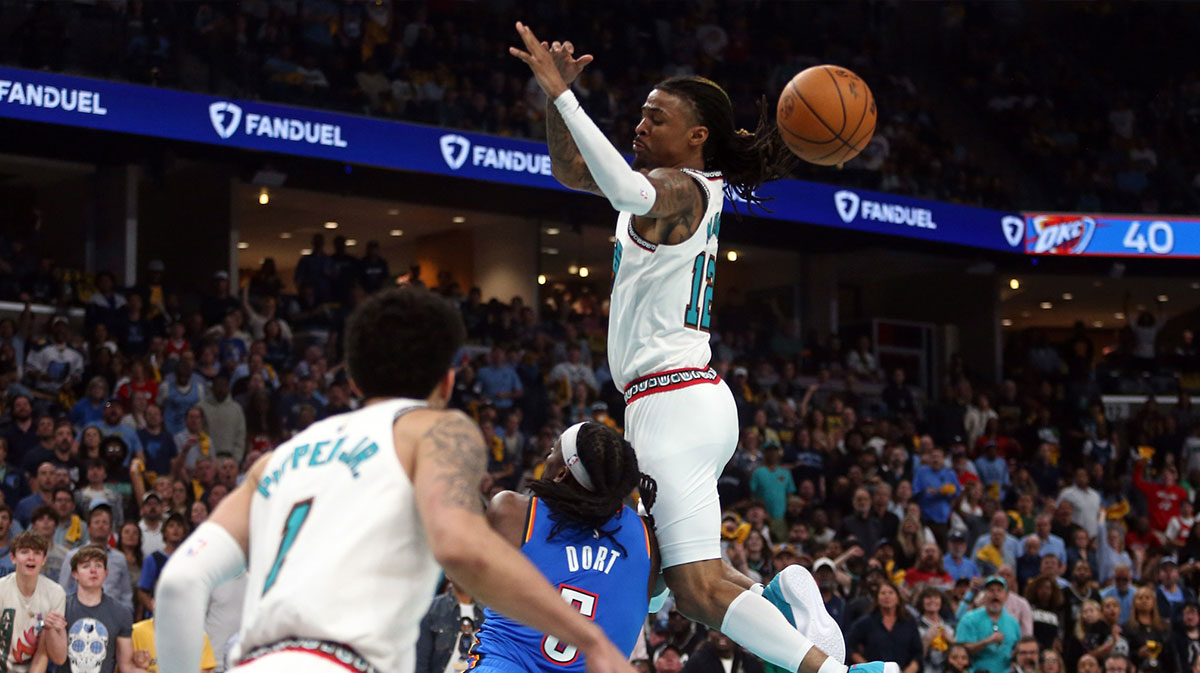 Grizzlies guard Ja Morant (12) looses control of the ball as he is fouled by Oklahoma City Thunder guard Luguentz Dort (5) during the second quarter during game three for the first round of the 2024 NBA Playoffs at FedExForum