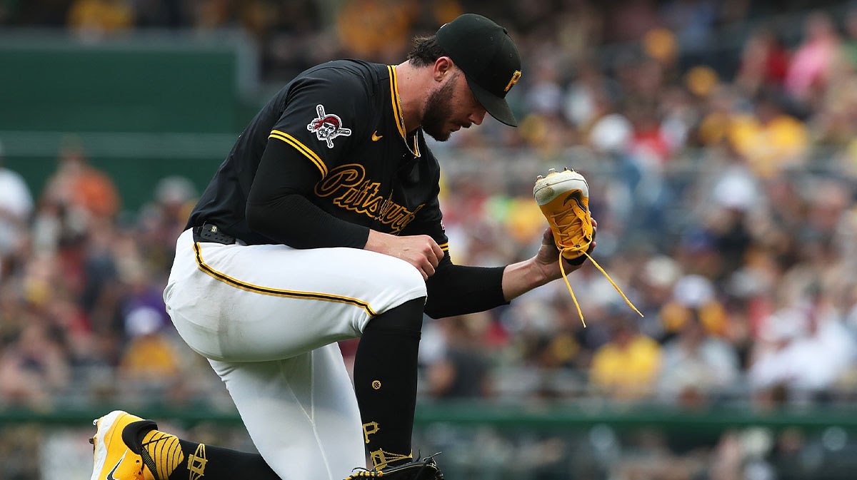 Pittsburgh Pirates starting pitcher Paul Skenes (30) empties dirt from his cleat against the Cleveland Guardians during the sixth inning at PNC Park.