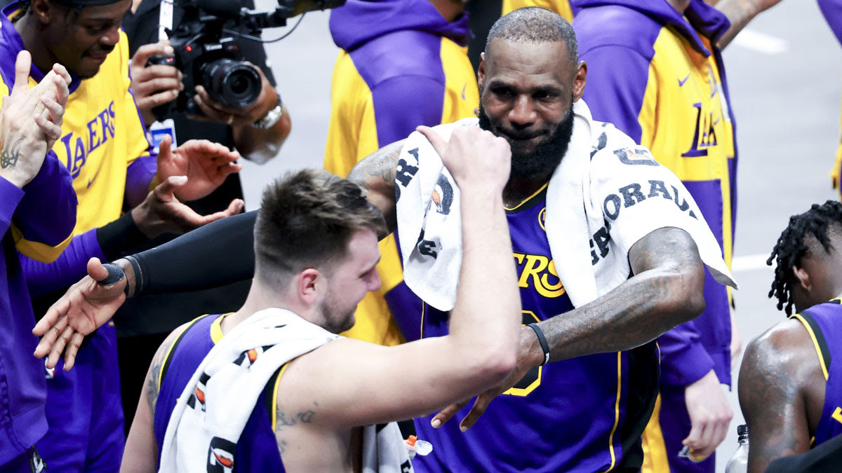 Los Angeles Lakers forward LeBron James (23) celebrates with Los Angeles Lakers guard Luka Doncic (77) during the fourth quarter against the Dallas Mavericks at American Airlines Center.