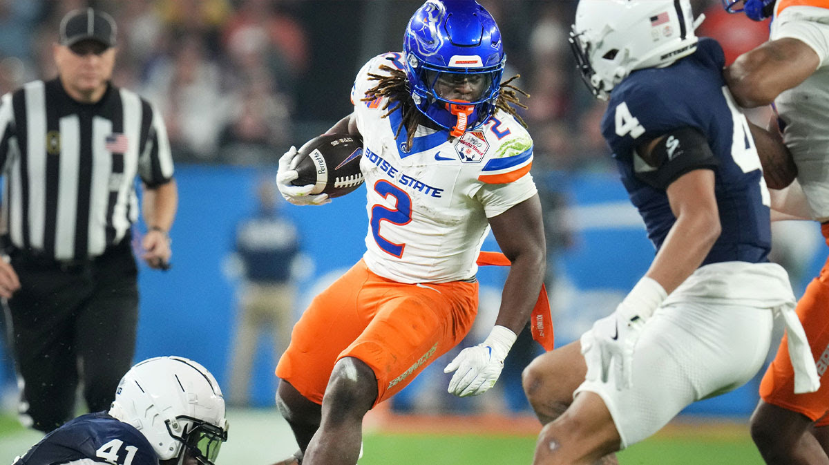 Boise State Broncos running back Ashton Jeanty (2) runs past Penn State Nittany Lions linebacker Kobe King (41) during their Vrbo Fiesta Bowl matchup at State Farm Stadium on Dec. 31, 2024.