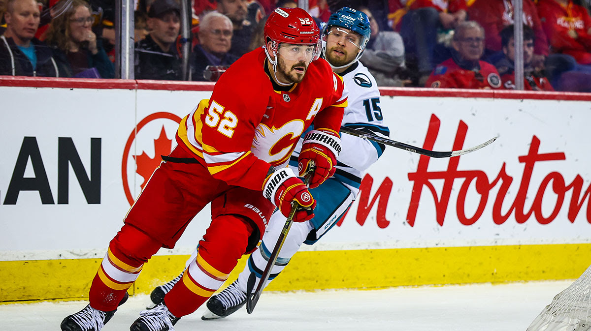 Calgary Flames defenseman MacKenzie Weegar (52) controls the puck against the San Jose Sharks during the third period at Scotiabank Saddledome.
