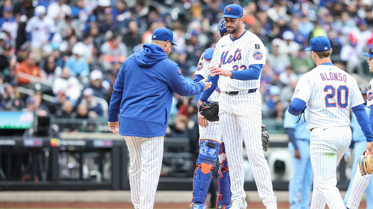 New York Mets starting pitcher David Peterson (23) is taken out of the game in the fifth inning by manager Carlos Mendoza (64) against the Toronto Blue Jays at Citi Field.