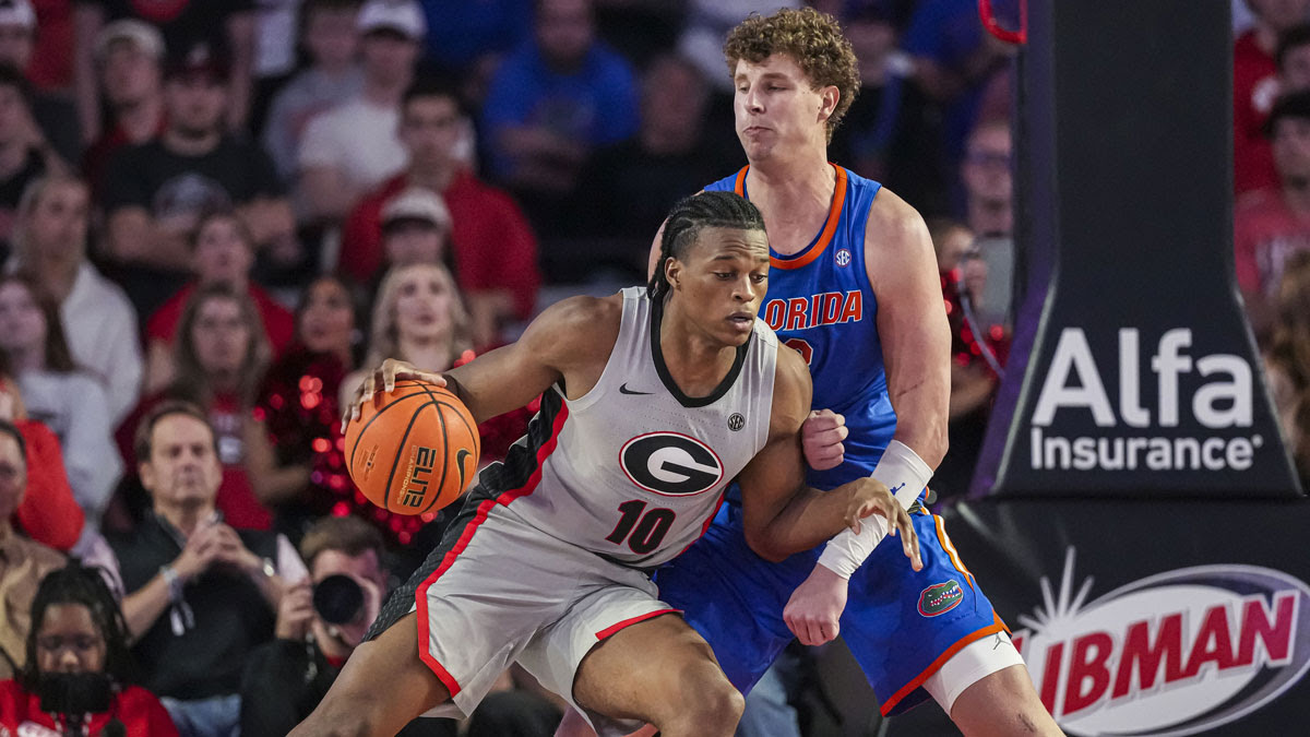 Georgia Bulldogs forward RJ Godfrey (10) dribbles against Florida Gators center Micah Handlogten (3) during the second half at Stegeman Coliseum.