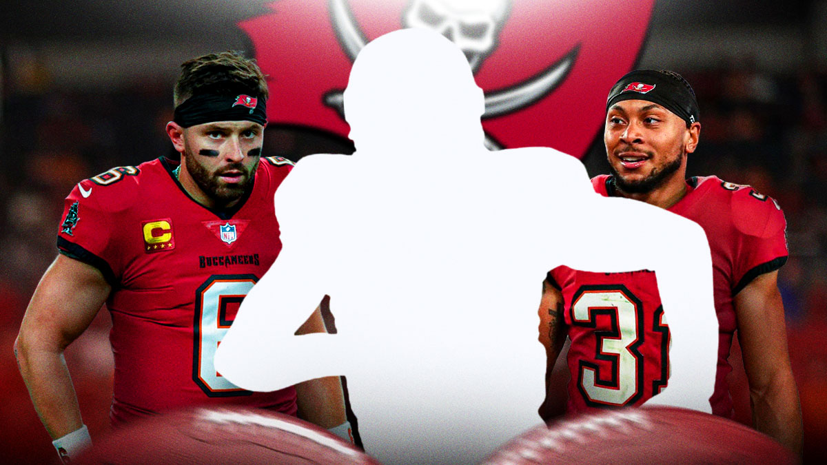 Mystery player in the middle, Baker Mayfield and Antoine Winfield Jr around him, Buccaneers logo in the background
