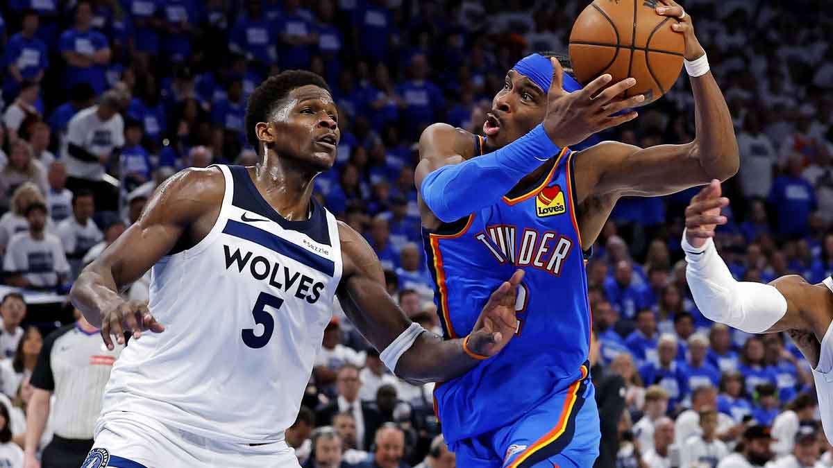Oklahoma City Thunder guard Shai Gilgeous-Alexander (2) drives to the basket against Minnesota Timberwolves guard Anthony Edwards (5) and guard Mike Conley (10) during the fourth quarter in game five of the western conference finals for the 2025 NBA Playoffs at Paycom Center.