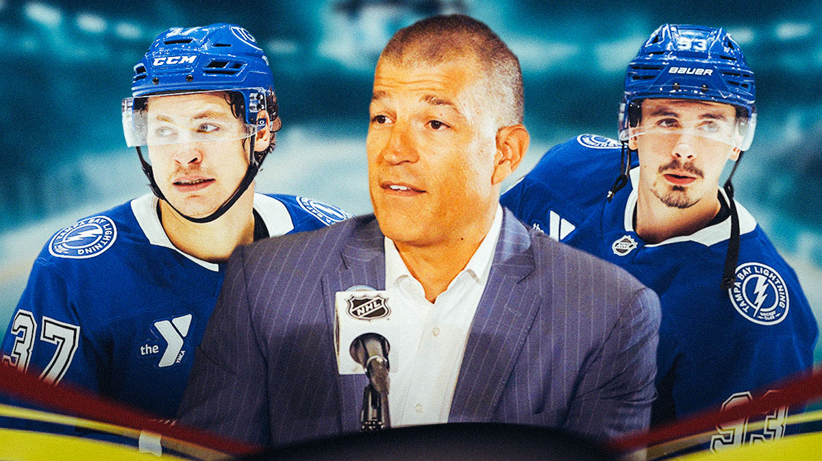 Julien BriseBois in middle, Gage Goncalves and Yanni Gourde on either side, hockey rink in background Tampa Bay Lightning