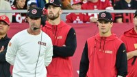 Jan 5, 2025; Glendale, Arizona, USA; San Francisco 49ers quarterback Brock Purdy (right) and head coach Kyle Shanahan (left) look on the in second half against the Arizona Cardinals at State Farm Stadium. Mandatory Credit: Matt Kartozian-Imagn Images