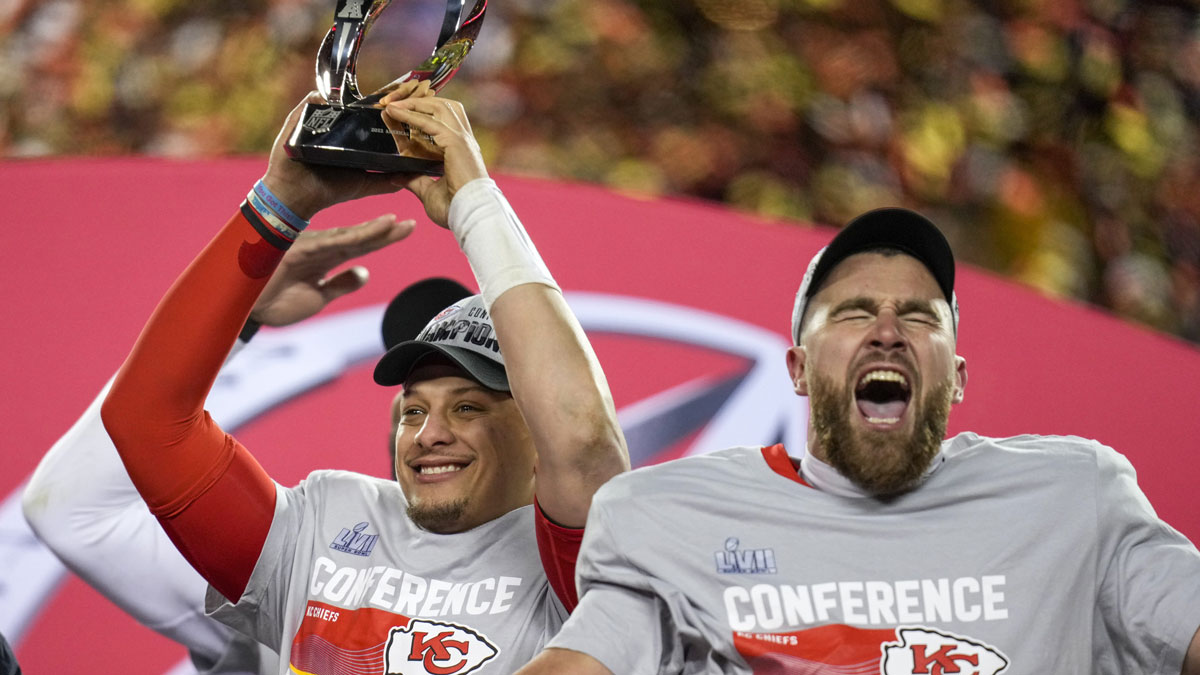 Kansas City Chiefs quarterback Patrick Mahomes (15) raises the Lamar Hunt Trophy with tight end Travis Kelce (87) after the AFC championship NFL game between the Cincinnati Bengals and the Kansas City Chiefs on Jan. 29, 2023, at Arrowhead Stadium in Kansas City.