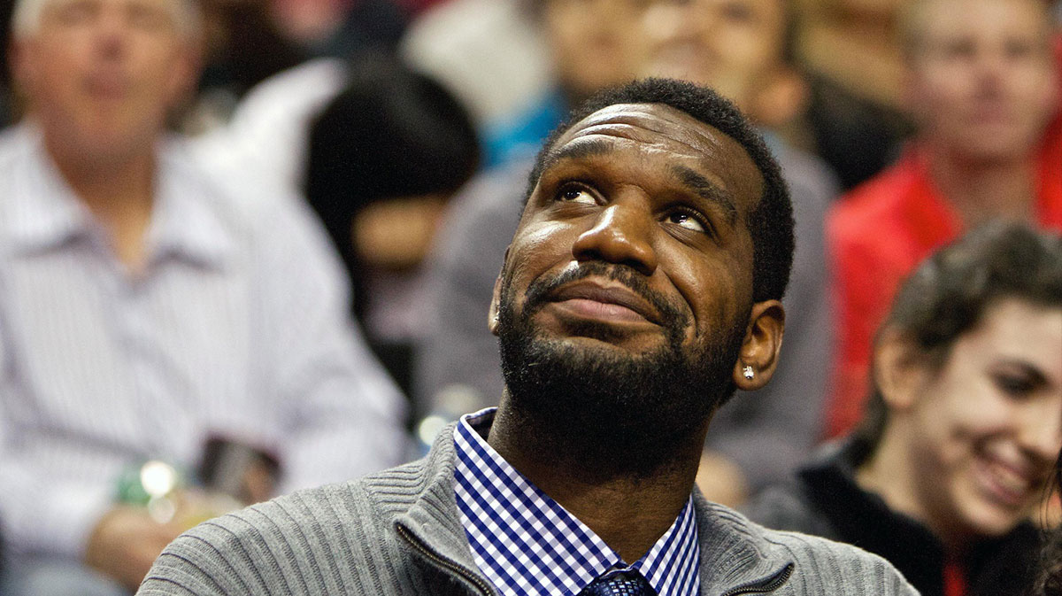 Portland Trail Blazers former center Greg Oden smiles while watching the Trail Blazers play against the Memphis Grizzlies at the Rose Garden.