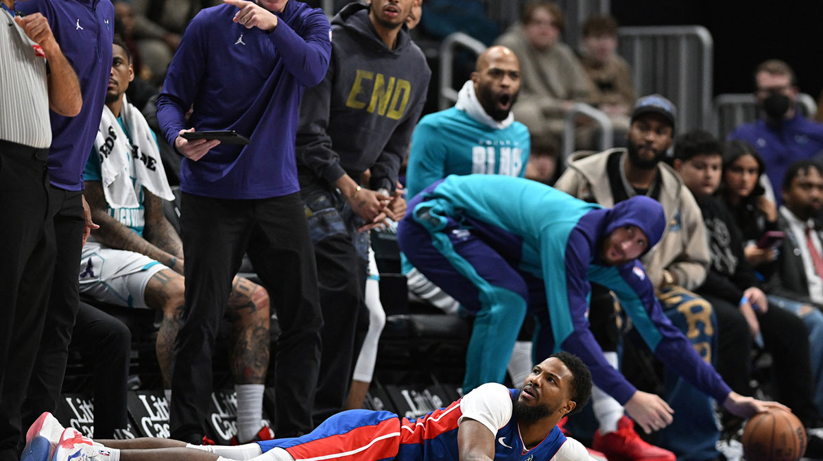 Detroit Pistons guard Malik Beasley (5) looks to the officials after falling to the court and losing the ball out of bounds in front of the Charlotte Hornets bench in the third quarter at Little Caesars Arena.