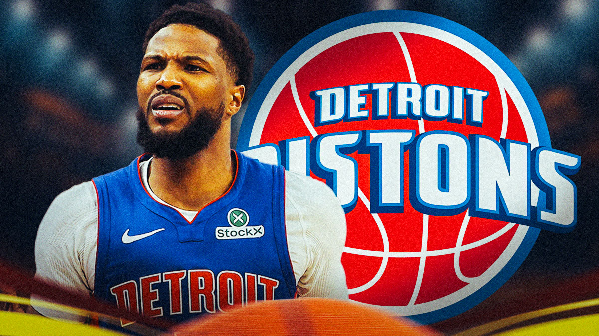 Malik Beasley playing basketball. Pistons logo in background.