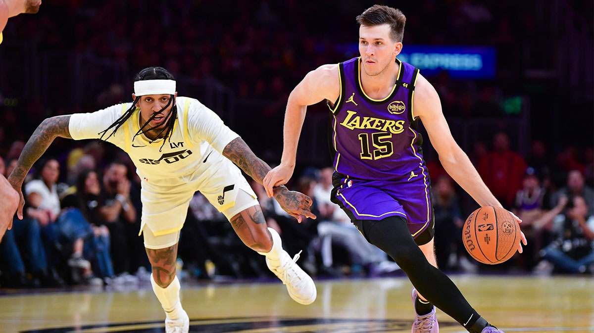The Los Angeles Austin Reaves Lakers goalkeeper (15) moves the ball against the Utah jazz goalkeeper, Jordan Clarkson (00) during the first half at Crypto.com Arena.