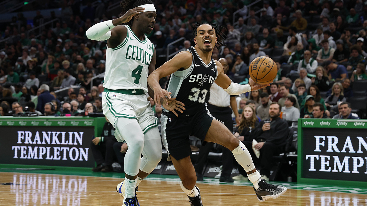 San Antonio Spurs guard Tre Jones (33) drives on Boston Celtics guard Jrue Holiday (4) during the second half at TD Garden.