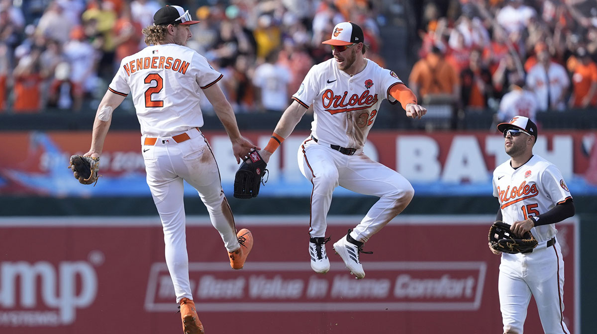 Baltimore Orioles shortstop Gunnar Henderson (2) and right fielder Ryan O'Hearn (32) do a leaping low five to celebrate the victory against the St. Louis Cardinals during the ninth inning at Oriole Park at Camden Yards.