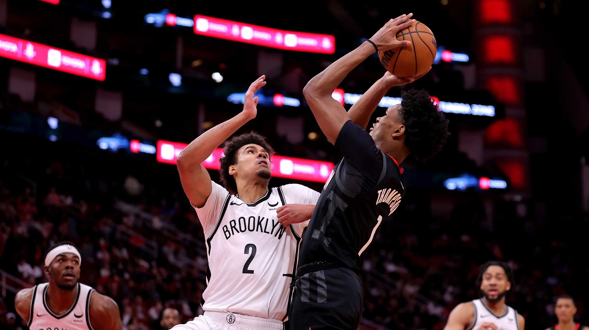 Houston Rockets forward Amen Thompson (1) shoots against Brooklyn Nets forward Cameron Johnson (2) during the fourth quarter at Toyota Center.