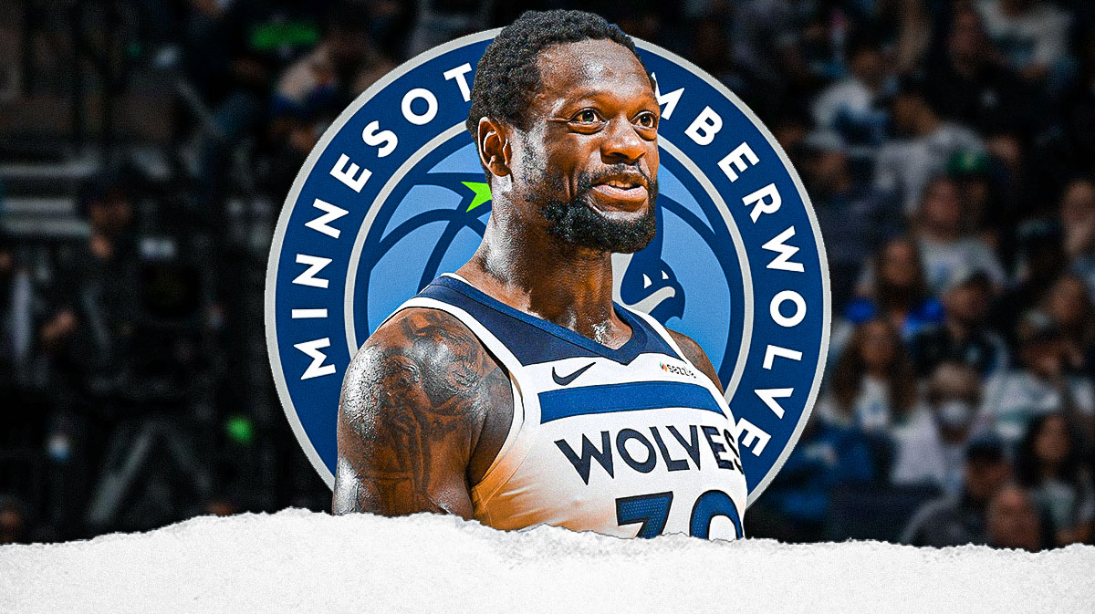 Julius Randle playing for the Timberwolves. T-Wolves logo in background.