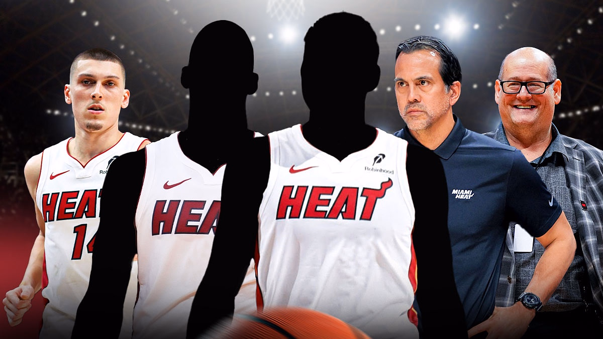 Two mystery players in Miami Heat jerseys in the middle - Tyler Herro, head coach Erik Spoelstra, and GM Andy Elisburg around them - Miami Heat wallpaper in the background