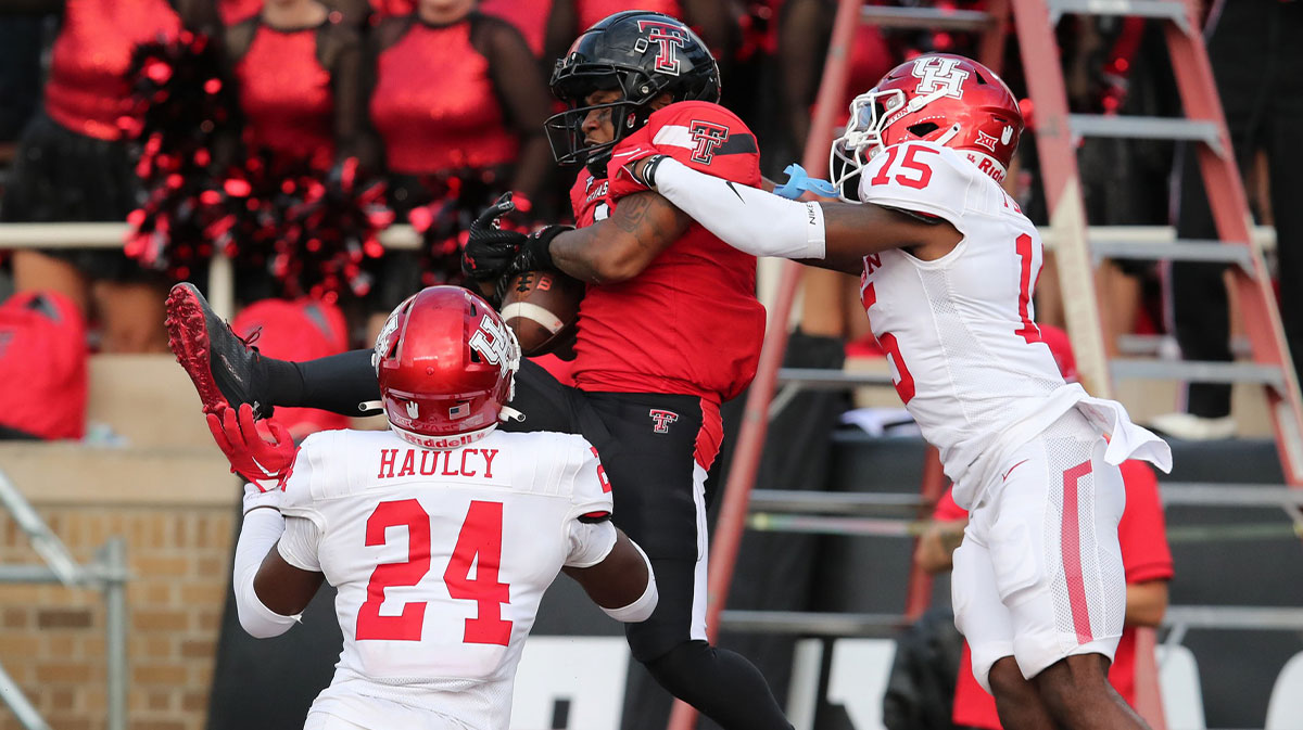 Texas Tech Red Raiders wide receiver Myles Price (1) catches a touchdown pass in front of Houston Cougars defensive back Malik Flemming (15) and defensive safety AJ Haulcy (24) in the second half at Jones AT&T Stadium and Cody Campbell Field.