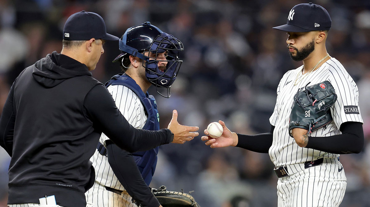 New York Yankees manager Aaron Boone (17) takes the ball from relief pitcher Devin Williams (38) during a pitching change during the ninth inning against the Toronto Blue Jays at Yankee Stadium.