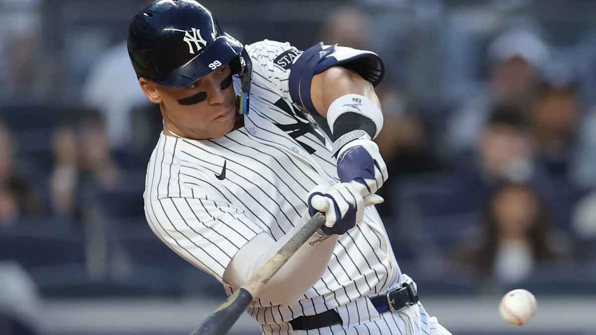 May 20, 2025; Bronx, New York, USA; New York Yankees right fielder Aaron Judge (99) hits a single against the Texas Rangers during the fourth inning at Yankee Stadium. Mandatory Credit: Brad Penner-Imagn Images. Judge tied Shohei Ohtani for MLB HR lead.