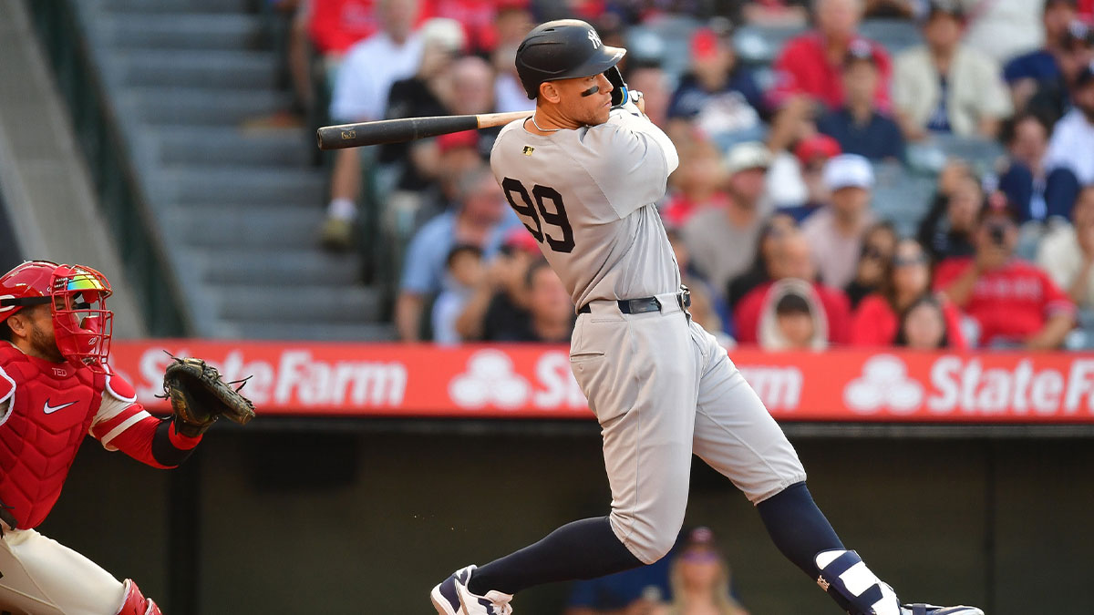 May 27, 2025; Anaheim, California, USA; New York Yankees right fielder Aaron Judge (99) hits a single against the Los Angeles Angels during the first inning at Angel Stadium. Mandatory Credit: Gary A. Vasquez-Imagn Images