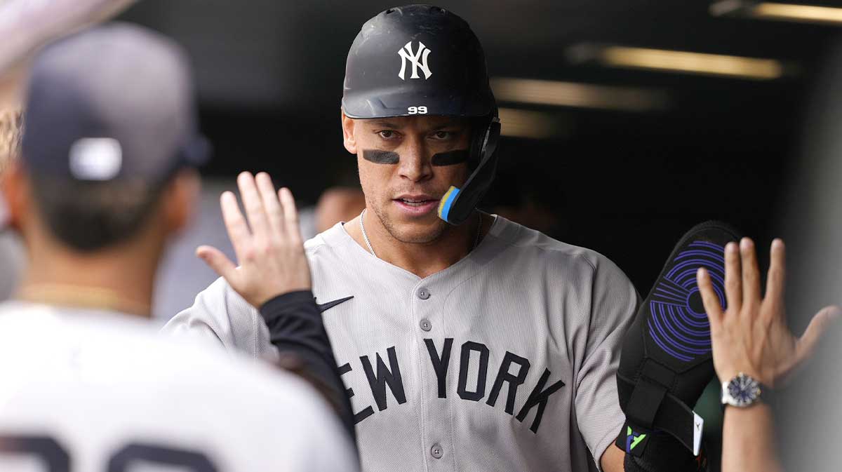 May 24, 2025; Denver, Colorado, USA; New York Yankees right fielder Aaron Judge (99) celebrates scoring a run in the fifth inning against the Colorado Rockies at Coors Field.