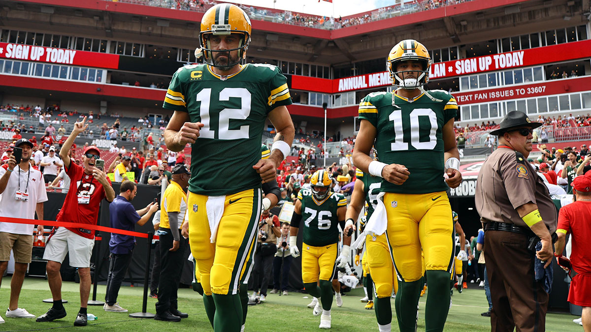 Green Bay Packers quarterbacks Aaron Rodgers (12) and Jordan Love (10) run out onto the field against the Tampa Bay Buccaneers at Raymond James Stadium.
