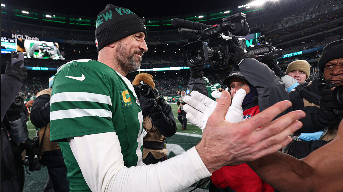 New York Jets quarterback Aaron Rodgers (8) shakes hands with a Miami Dolphins player after the game at MetLife Stadium.
