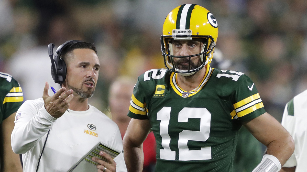 Green Bay Packers head coach Matt LaFleur talks with quarterback Aaron Rodgers (12) in between quarters against the Chicago Bears during their football game at Lambeau Field.