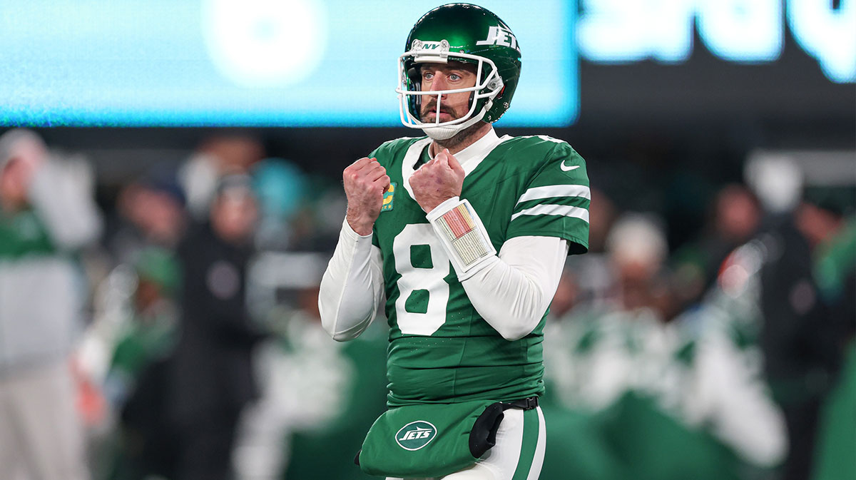 New York Jets quarterback Aaron Rodgers (8) gestures towards the Miami Dolphins bench during the second half at MetLife Stadium.