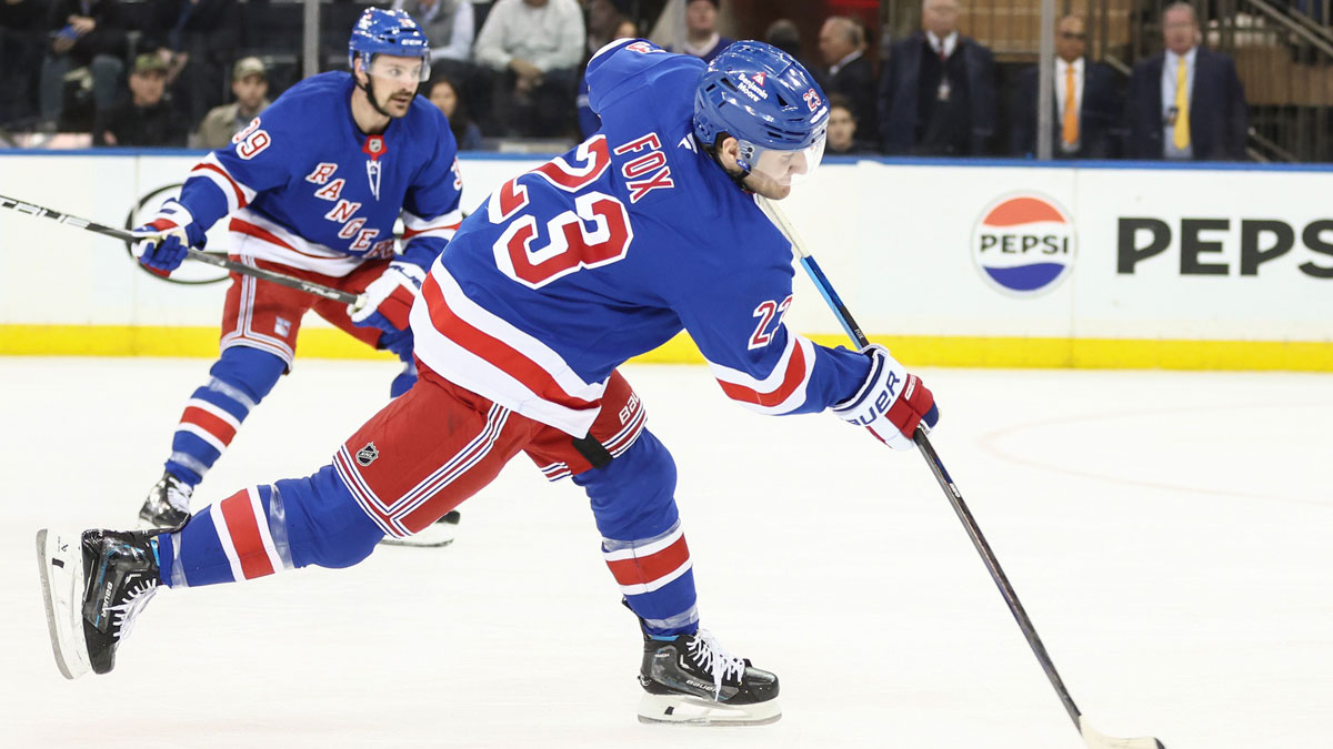 New York Rangers defenseman Adam Fox (23) attempts a shot on goal in the first period against the Tampa Bay Lightning at Madison Square Garden.