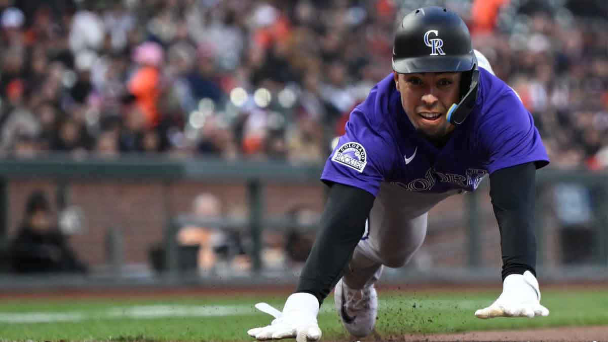 Colorado Rockies shortstop Alan Trejo (31) slides home against the San Francisco Giants in the third inning at Oracle Park.