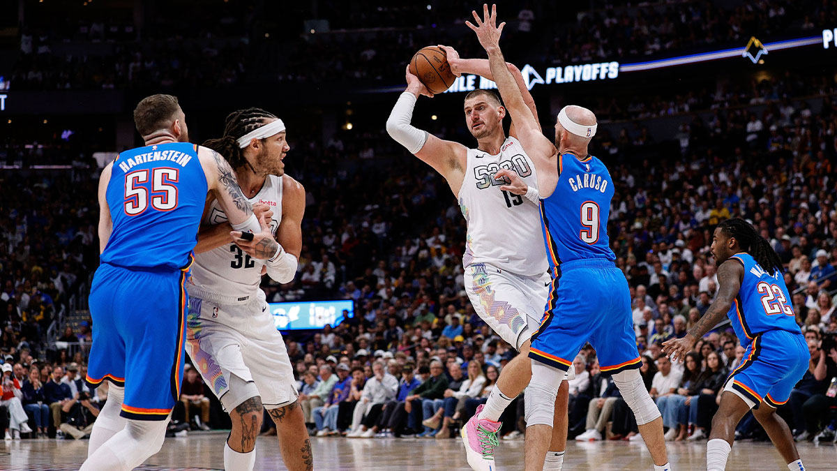 Denver Nuggets center Nikola Jokic (15) looks to pass the ball under pressure from Oklahoma City Thunder guard Alex Caruso (9) as center Isaiah Hartenstein (55) and forward Aaron Gordon (32) battle for position in the third quarter during game six of the second round for the 2025 NBA Playoffs at Ball Arena.