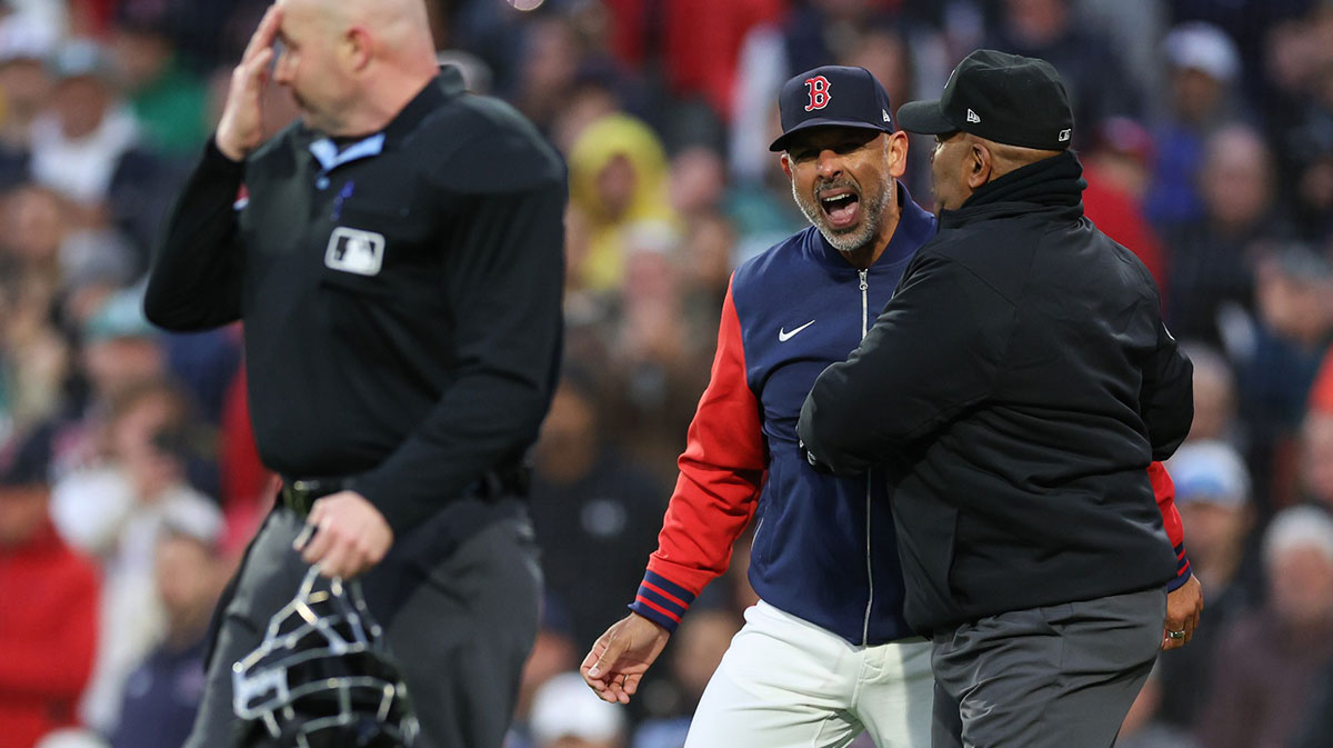 Massachusetts, USA; Boston Red Sox manager Alex Cora (13) yells at home plate umpire Mike Estabrook (83) during the third inning against the New York Mets at Fenway Park
