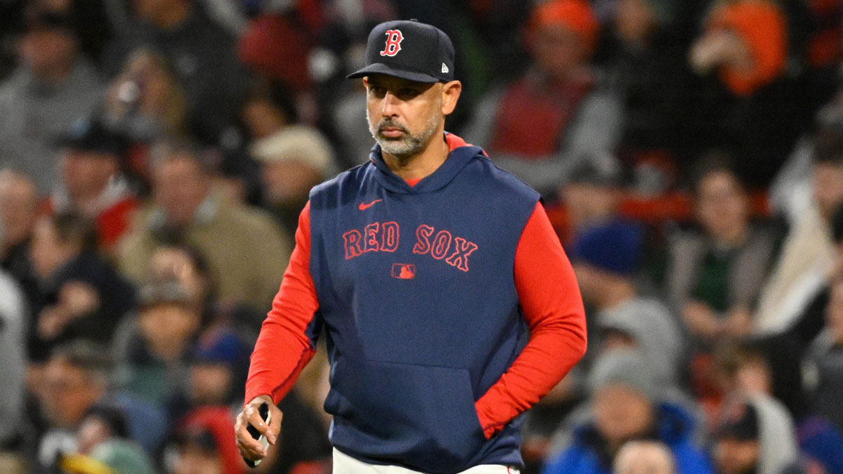 Boston Red Sox manager Alex Cora (13) walks to the mound during the sixth inning against the New York Mets at Fenway Park.