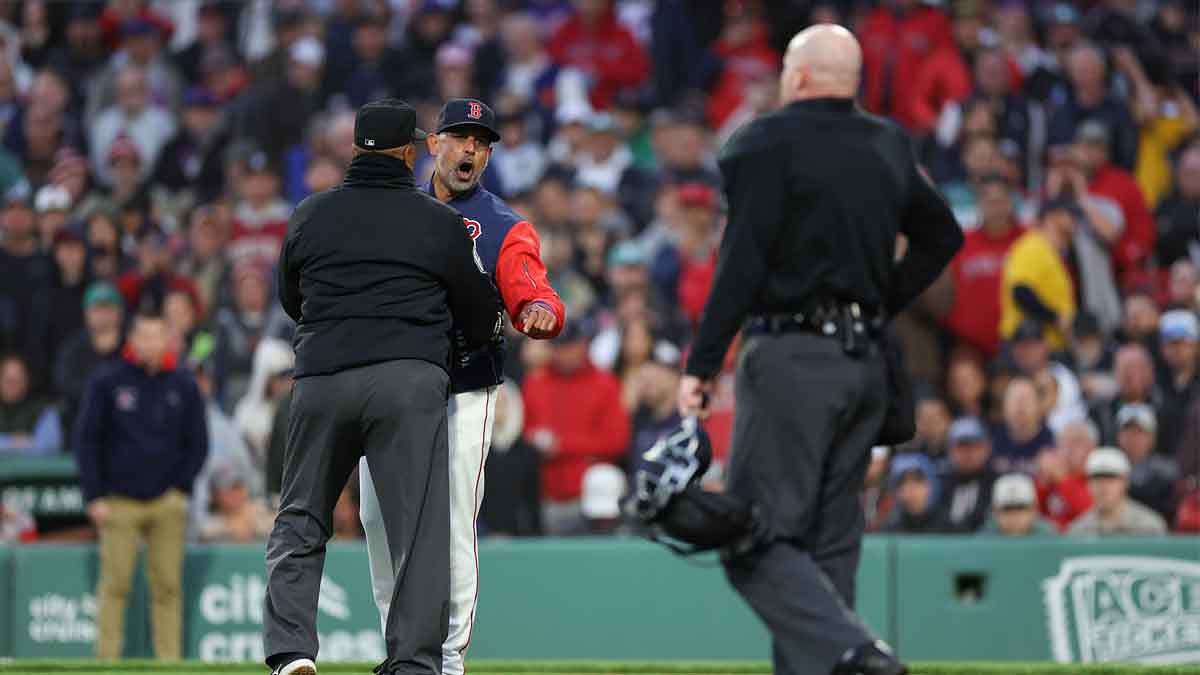 Boston Red Sox manager Alex Cora (13) yells at home plate umpire Mike Estabrook (83) during the third inning against the New York Mets.