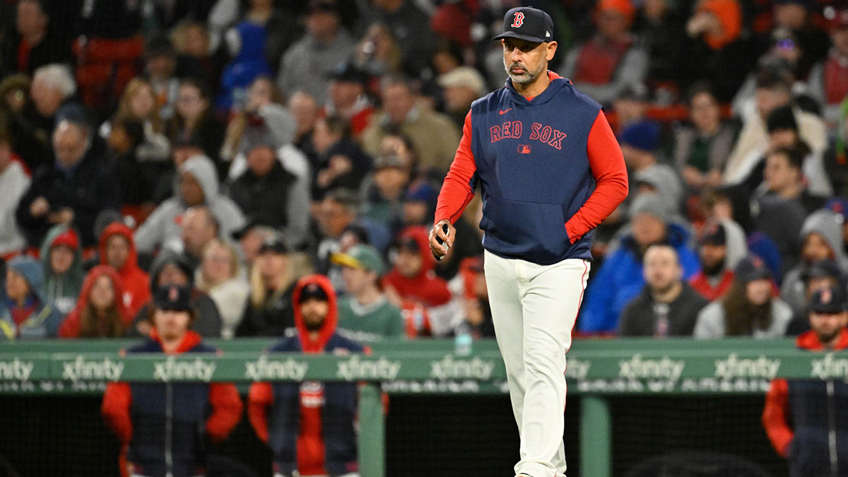 Boston Red Sox manager Alex Cora (13) walks to the mound during the sixth inning against the New York Mets at Fenway Park.