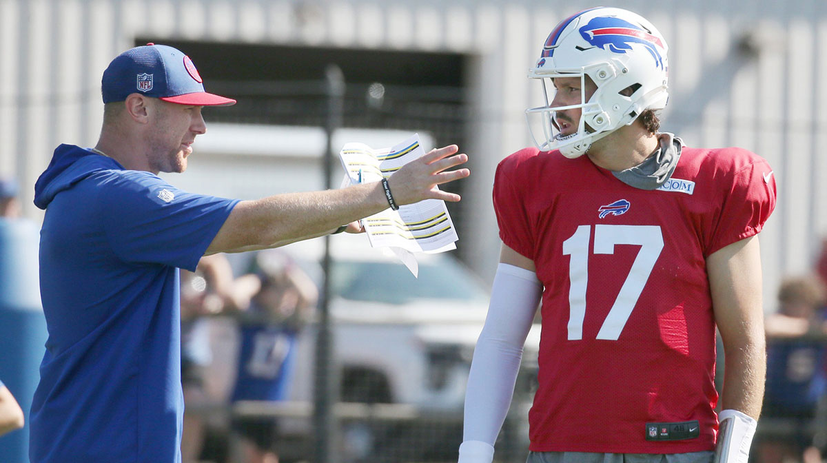 Bills quarterback Josh Allen talks with offensive coordinator Joe Brady between drills.