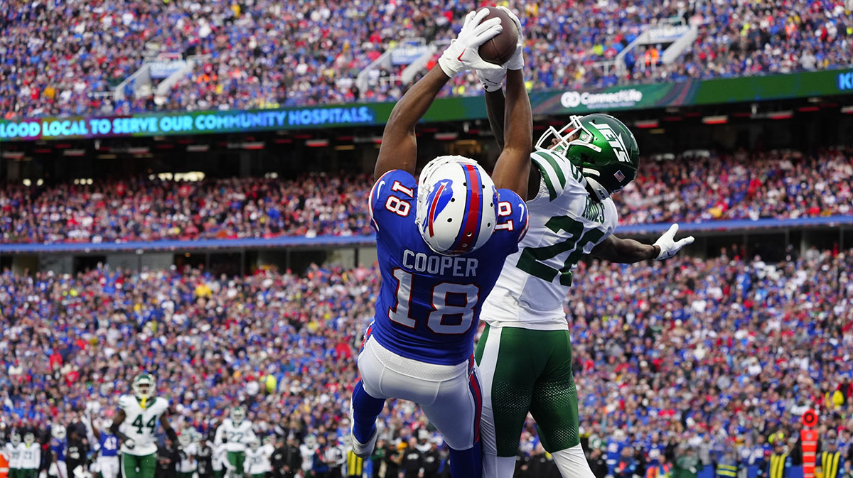 Buffalo Bills wide receiver Amari Cooper (18) makes a catch for a touchdown against New York Jets cornerback Brandin Echols (26) during the second half at Highmark Stadium.