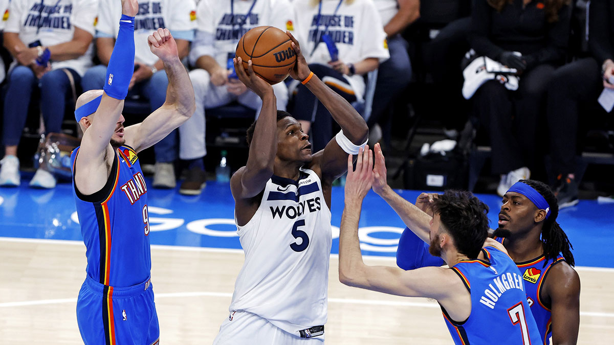 Minnesota Timberwolves guard Anthony Edwards (5) drives to the basket against Oklahoma City Thunder guard Alex Caruso (9) during the third quarter in game five of the western conference finals for the 2025 NBA Playoffs at Paycom Center.