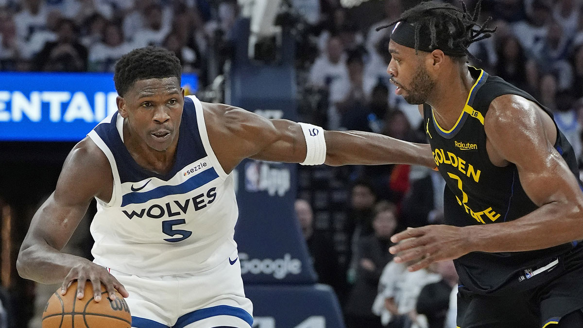 Minnesota Timberwolves guard Anthony Edwards (5) dribbles around Golden State Warriors forward Buddy Hield (7) in the first quarter during game one of the second round for the 2025 NBA Playoffs at Target Center.