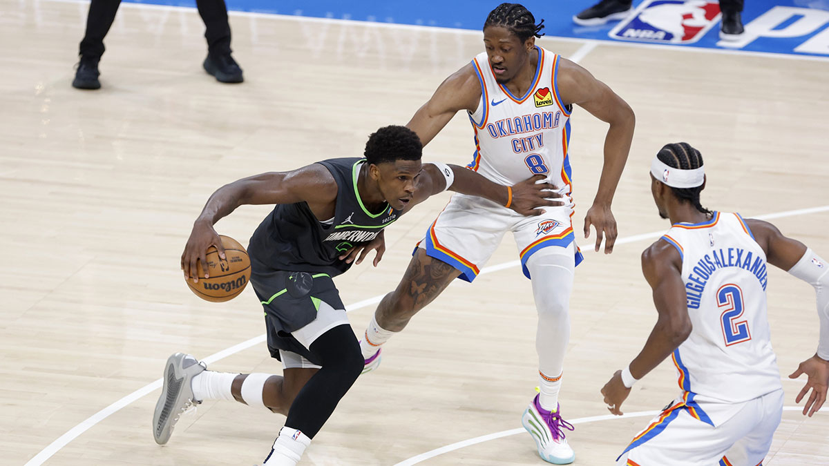 Minnesota Timberwolves guard Anthony Edwards (5) drives against Oklahoma City Thunder forward Jalen Williams (8) and guard Shai Gilgeous-Alexander (2) in the third quarter during game one of the western conference finals for the 2025 NBA Playoffs at Paycom Center.