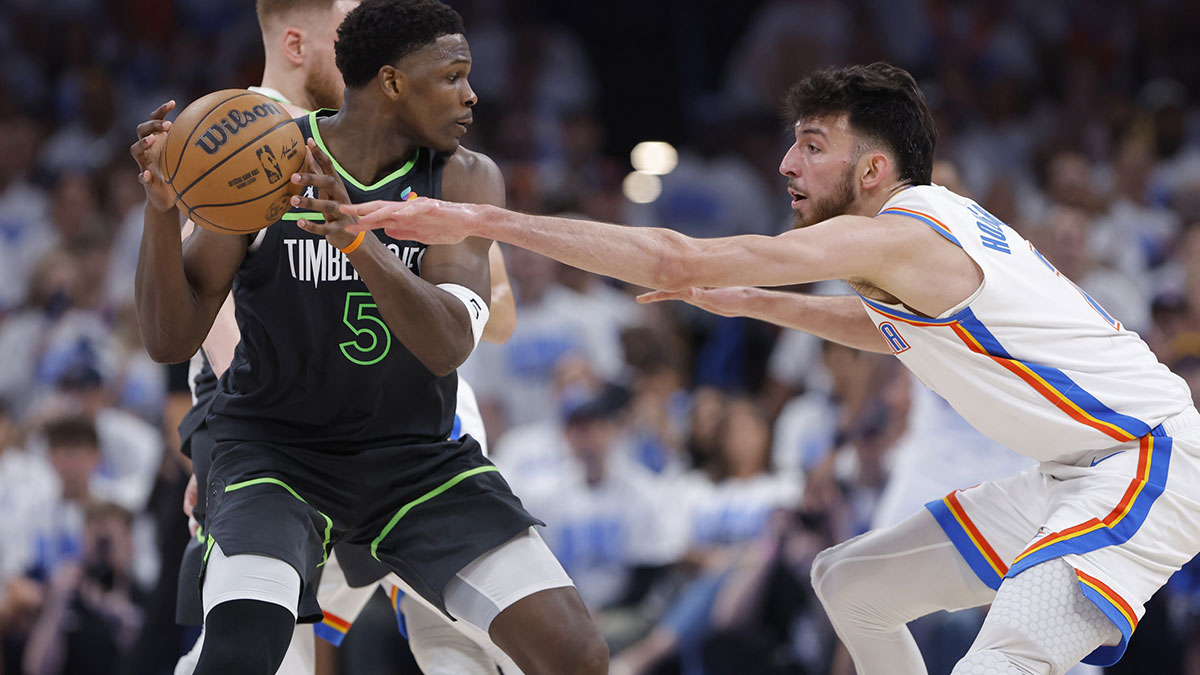 Minnesota Timberwolves guard Anthony Edwards (5) controls the ball against Oklahoma City Thunder forward Chet Holmgren (7) in the fourth quarter during game one of the western conference finals for the 2025 NBA Playoffs at Paycom Center.