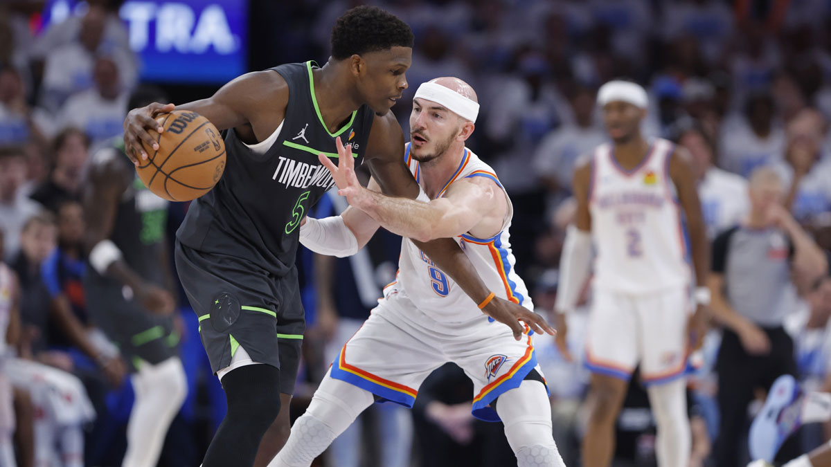 Minnesota Timberwolves guard Anthony Edwards (5) dribbles against Oklahoma City Thunder guard Alex Caruso (9) in the fourth quarter during game one of the western conference finals for the 2025 NBA Playoffs at Paycom Center.