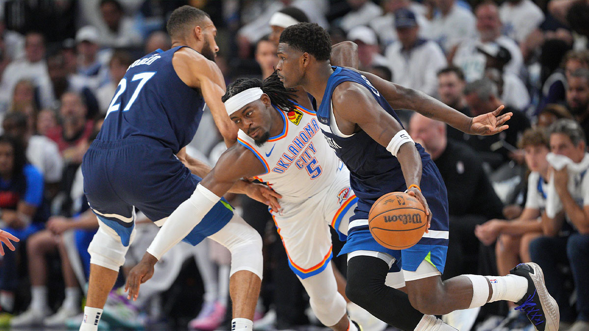Minnesota Timberwolves guard Anthony Edwards (5) dribbles the ball past Oklahoma City Thunder guard Luguentz Dort (5) during the first half in game three of the western conference finals for the 2025 NBA Playoffs at Target Center.