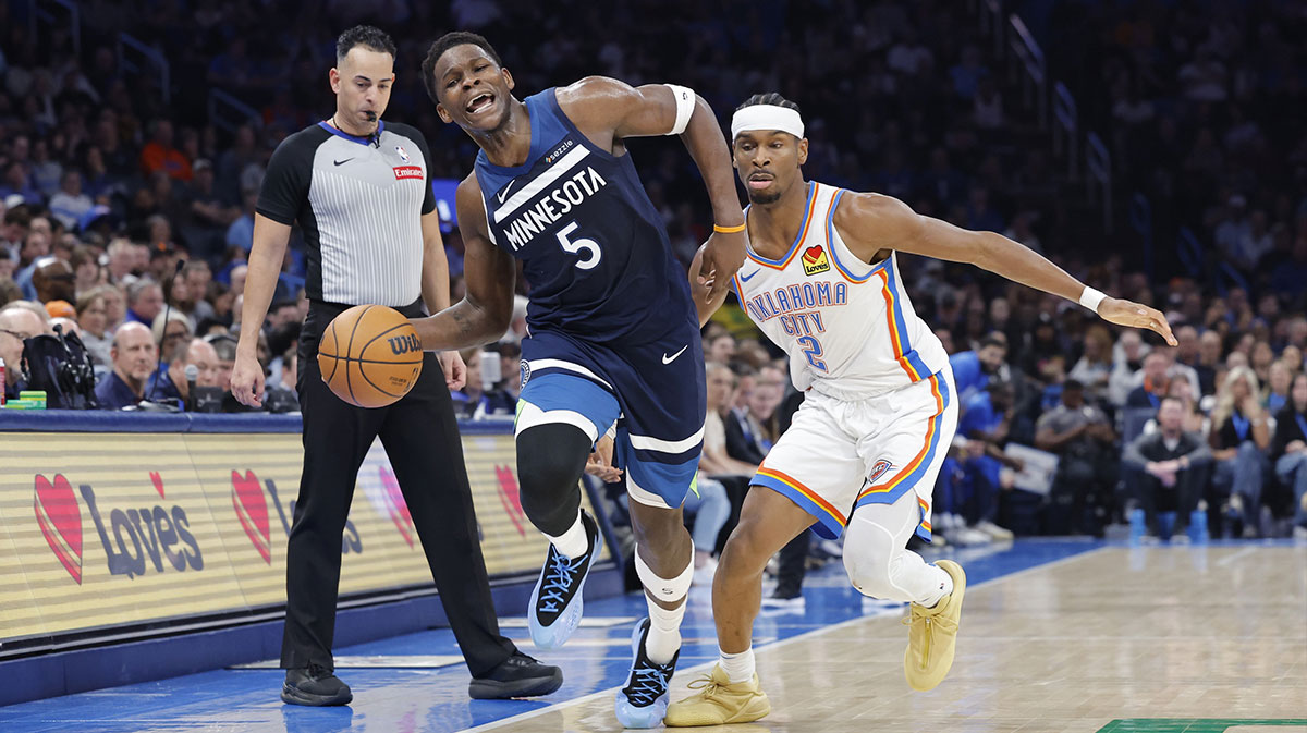 Minnesota Timberwolves guard Anthony Edwards (5) works to keep the ball inbounds as Oklahoma City Thunder guard Shai Gilgeous-Alexander (2) defends during the second half at Paycom Center.