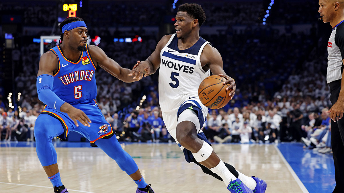 Minnesota Timberwolves guard Anthony Edwards (5) drives to the basket against Oklahoma City Thunder guard Luguentz Dort (5) during the second quarter in game five of the western conference finals for the 2025 NBA Playoffs at Paycom Center.