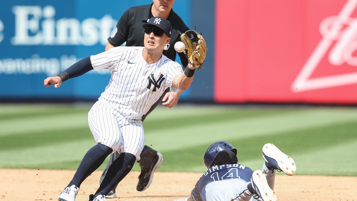 Tampa Bay Rays pinch runner Chandler Simpson (14) beats the tag of New York Yankees shortstop Anthony Volpe (11) for a stolen base in the eighth inning at Yankee Stadium.