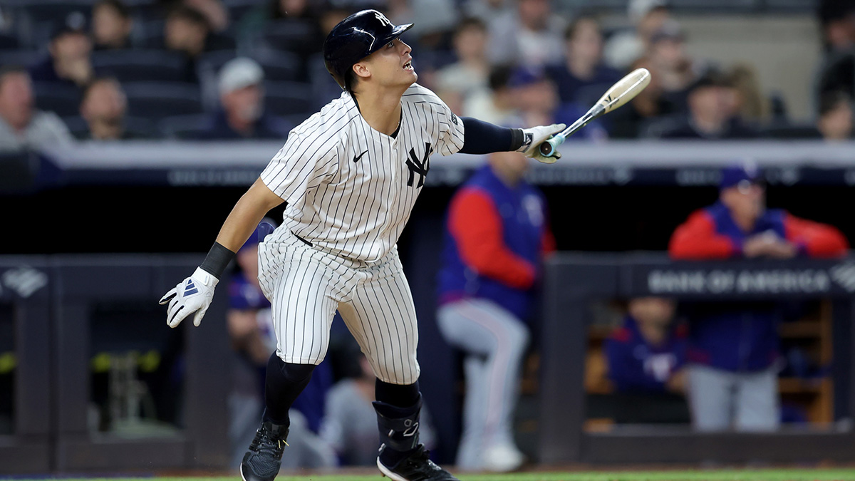 New York Yankees shortstop Anthony Volpe (11) follows through on an RBI doubt against the Texas Rangers during the sixth inning at Yankee Stadium