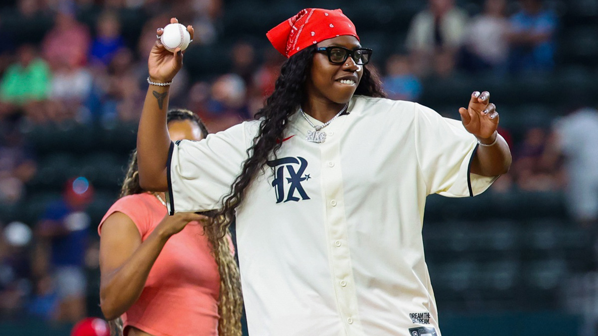 Dallas Wings player Arike Ogunbowale throws out the first pitch before the game between the Texas Rangers and Houston Astros at Globe Life Field.